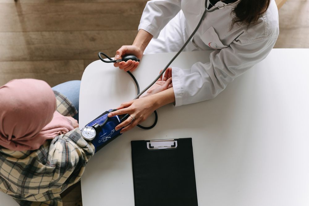 Clinician recording a patient's blood pressure reading